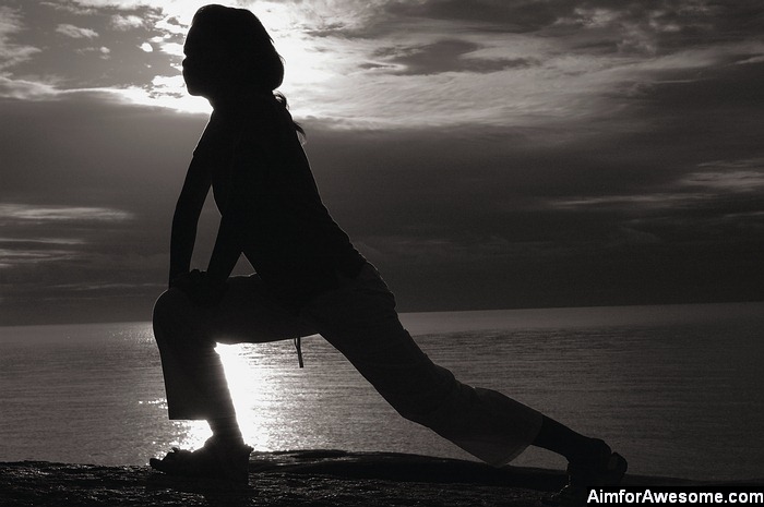 Girl stretching in silhouette