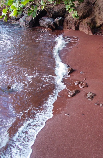 Kaihalulu is a red sand beach, and nudist beach in Hana, Maui.