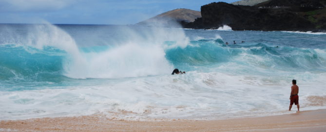 man bodysurfing at Sandy Beach